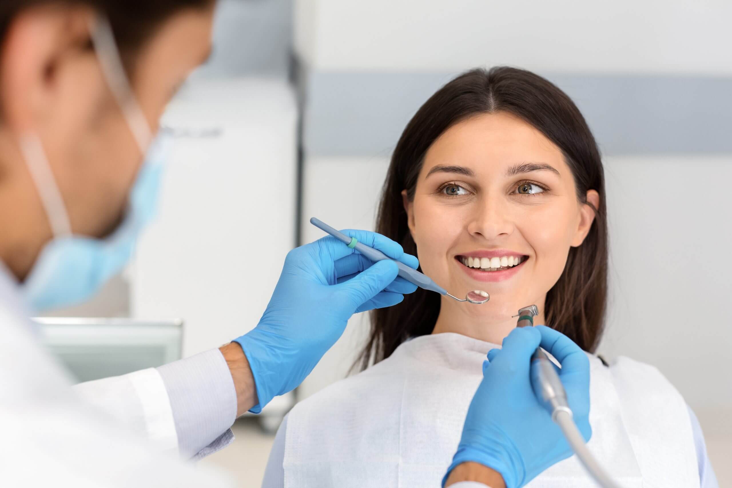 Smiling woman looking at dentist with trust